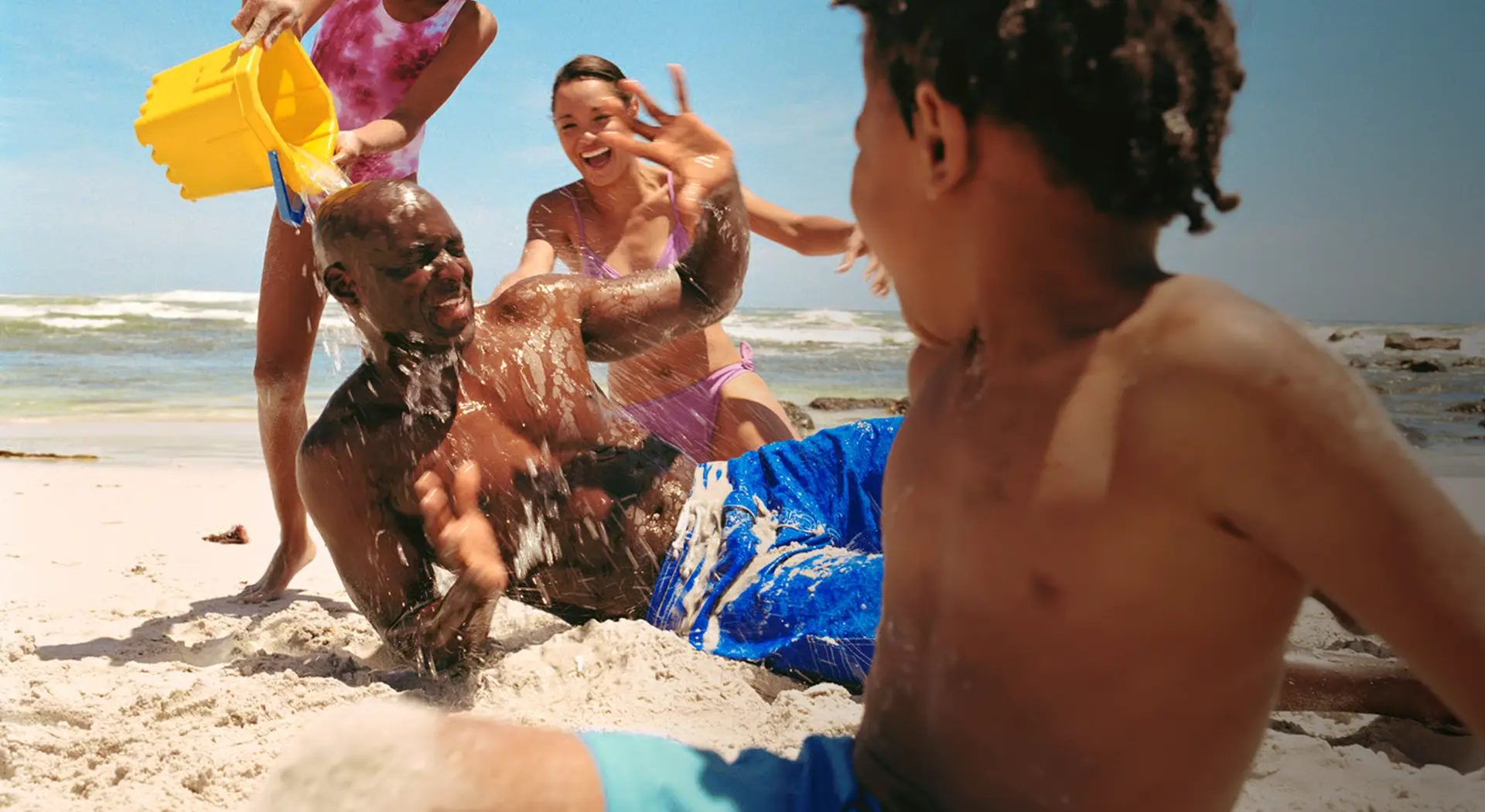 A family playing together on a beach